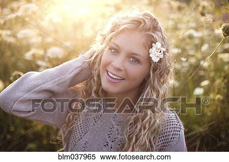 Woman sitting in tall flowers View Large Photo Image Stock Photography - Woman sitting in tall flowers. Fotosearch