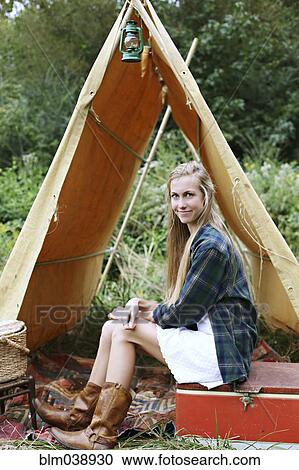Woman sitting on cooler at camping tent View Large Photo Image Stock Image - Woman sitting on cooler at camping tent. Fotosearch