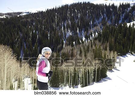 Stock Photograph - Woman skiing on snowy slope. Fotosearch