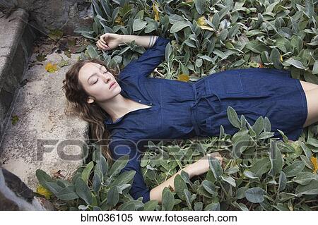 Woman sleeping in leafy garden View Large Photo Image Stock Photography - Woman sleeping in leafy garden. Fotosearch