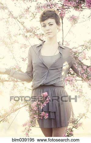 Woman standing in flowering trees View Large Photo Image Stock Photography - Woman standing in flowering trees. Fotosearch