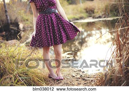 Woman standing near rural pond View Large Photo Image Stock Image - Woman standing near rural pond. Fotosearch
