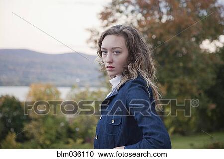 Woman walking outdoors near lake View Large Photo Image Stock Image - Woman walking outdoors near lake. Fotosearch