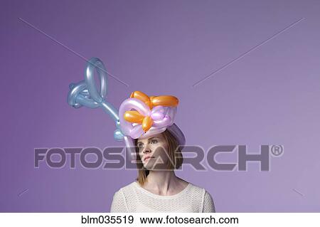 Stock Photo - Woman wearing balloon hat. Fotosearch