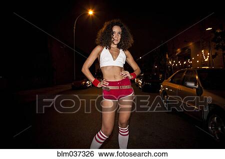 Stock Photograph - Woman wearing retro costume at night. Fotosearch