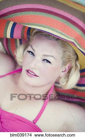 Picture - Woman wearing sun hat and bathing suit. Fotosearch