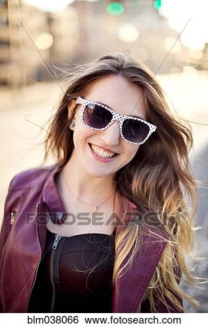 Woman wearing sunglasses in city View Large Photo Image Stock Photograph - Woman wearing sunglasses in city. Fotosearch