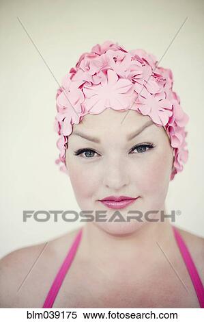 Stock Photography - Woman wearing swim cap and bathing suit. Fotosearch