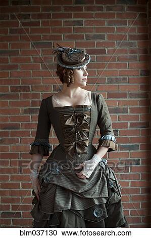 Woman wearing vintage gown and hat View Large Photo Image Stock Image - Woman wearing vintage gown and hat. Fotosearch