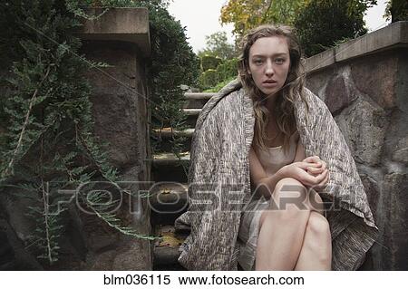 Woman wrapped in blanket sitting on stone steps View Large Photo Image Stock Photography - Woman wrapped in blanket sitting on stone steps. Fotosearch