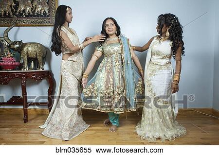 Women dressing bride in traditional dresses and jewelry View Large Photo Image Stock Photography - Women dressing bride in traditional dresses and jewelry. Fotosearch