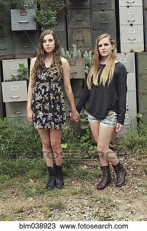 Women holding hands near dilapidated office drawers in garden View Large Photo Image Stock Image - Women holding hands near dilapidated office drawers in garden. Fotosearch