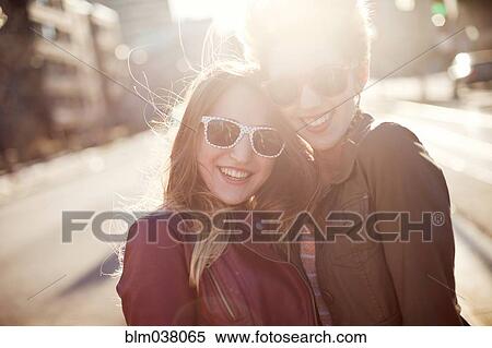 Women hugging on sunny city sidewalk View Large Photo Image Stock Photography - Women hugging on sunny city sidewalk. Fotosearch