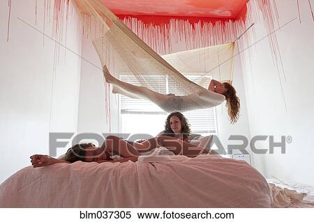 Women laying on bed and hammock under dripping ceiling View Large Photo Image Stock Photography - Women laying on bed and hammock under dripping ceiling. Fotosearch