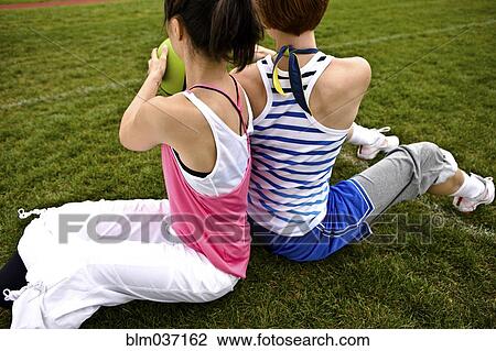 Stock Image - Women working out in field. Fotosearch