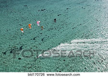 Aerial view of people kitesurfing on ocean View Large Photo Image Stock Photograph - Aerial view of people kitesurfing on ocean. Fotosearch
