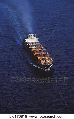 Stock Photo - Aerial view of shipping barge sailing on ocean. Fotosearch