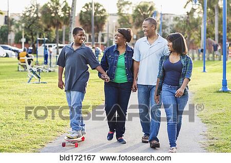 Stock Photo - African American family relaxing in park. Fotosearch