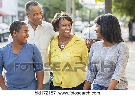Stock Photo - African American family walking in city. Fotosearch