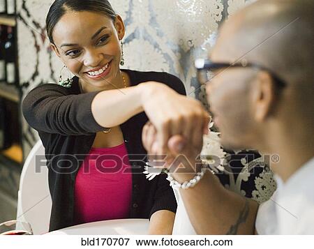 African American man kissing hand of girlfriend in restaurant View Large Photo Image Stock Photo - African American man kissing hand of girlfriend in restaurant. Fotosearch