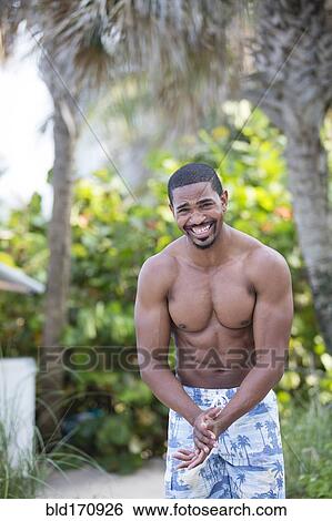 African American man wearing swim trunks on beach View Large Photo Image Stock Photograph - African American man wearing swim trunks on beach. Fotosearch