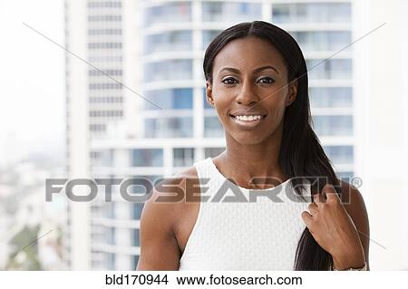 African American woman smiling on urban balcony View Large Photo Image Picture - African American woman smiling on urban balcony. Fotosearch