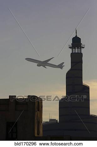 Airplane flying over Doha cityscape, Doha, Qatar View Large Photo Image Stock Photograph - Airplane flying over Doha cityscape, Doha, Qatar. Fotosearch
