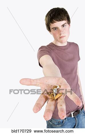 Angry man holding crumpled cigarette View Large Photo Image Stock Photo - Angry man holding crumpled cigarette. Fotosearch