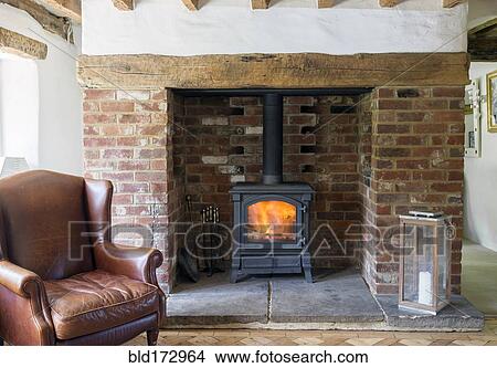 Armchair and fireplace in living room View Large Photo Image Picture - Armchair and fireplace in living room. Fotosearch
