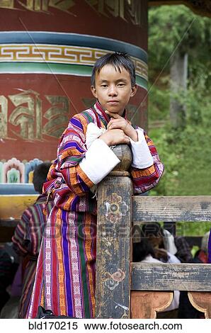 Stock Photography - Asian boy leaning on fence post. Fotosearch
