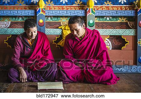 Stock Photo - Asian monks reading on temple floor. Fotosearch