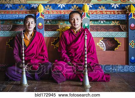 Stock Photography - Asian monks sitting on temple floor. Fotosearch