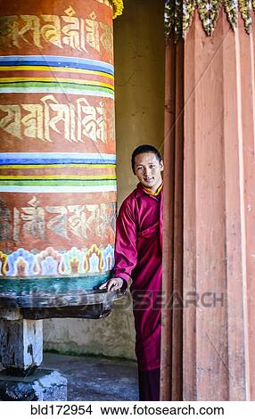 Picture - Asian monks standing by pillar in temple. Fotosearch