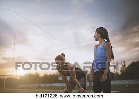 Stock Photograph - Athletes resting on sports field. Fotosearch
