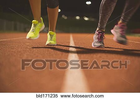 Athletes running on track on sports field View Large Photo Image Stock Photography - Athletes running on track on sports field. Fotosearch