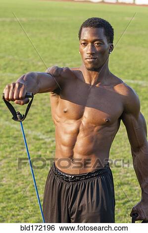 Stock Photograph - Black athlete working out on sports field. Fotosearch