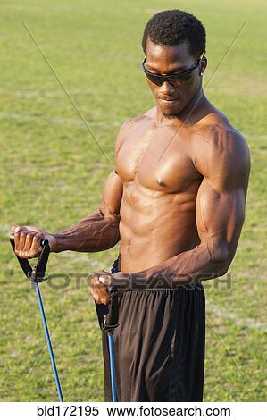 Stock Photography - Black athlete working out on sports field. Fotosearch