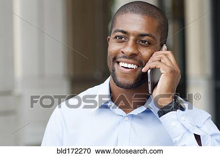 Black businessman talking on cell phone View Large Photo Image Stock Image - Black businessman talking on cell phone. Fotosearch