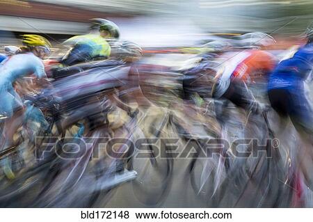 Stock Photo - Blurred view of cyclists competing in race. Fotosearch
