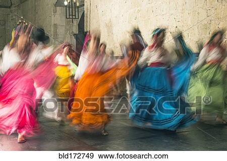 Stock Photo - Blurred view of women dancing in traditional dresses. Fotosearch