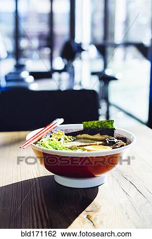 Stock Image - Bowl of ramen on restaurant table. Fotosearch