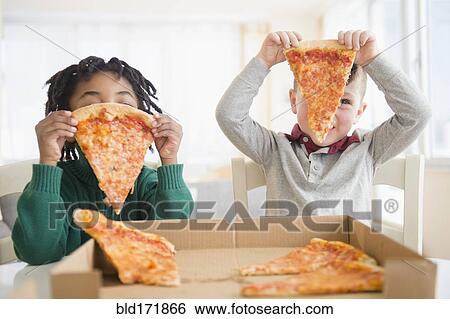 Stock Photograph - Boys eating pizza from cardboard box. Fotosearch