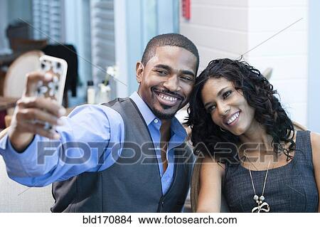 Business people taking selfie with cell phone in office View Large Photo Image Picture - Business people taking selfie with cell phone in office. Fotosearch