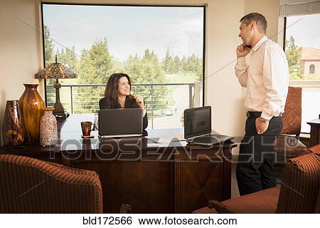 Stock Photograph - Business people talking in office. Fotosearch