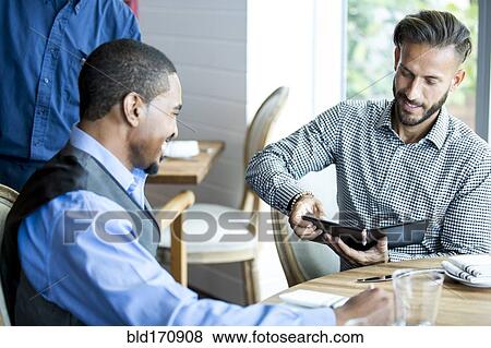 Businessman paying for lunch in cafe View Large Photo Image Stock Photo - Businessman paying for lunch in cafe. Fotosearch