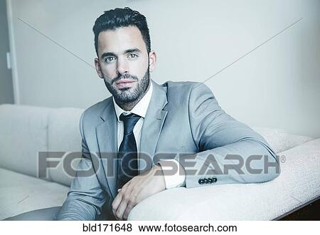Stock Photo - Businessman sitting on sofa. Fotosearch