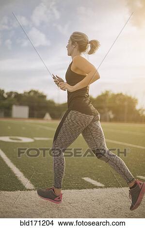 Caucasian athlete jogging on sports field View Large Photo Image Picture - Caucasian athlete jogging on sports field. Fotosearch