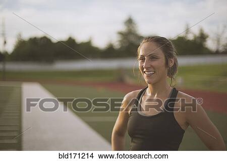 Caucasian athlete standing on sports field View Large Photo Image Picture - Caucasian athlete standing on sports field. Fotosearch