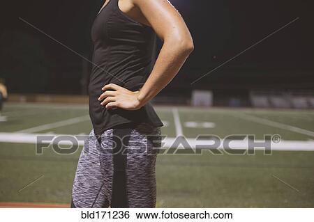 Stock Photograph - Caucasian athlete standing on sports field. Fotosearch