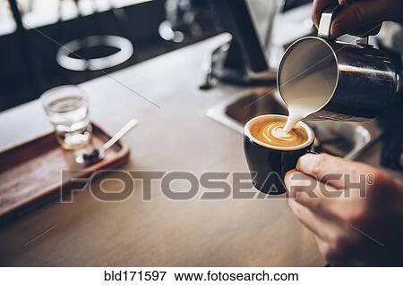 Caucasian barista pouring coffee drink in cafe View Large Photo Image Stock Photo - Caucasian barista pouring coffee drink in cafe. Fotosearch